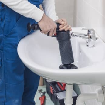 professional-plumber-unclogging-a-sink-2021-09-02-16-30-58-utc
